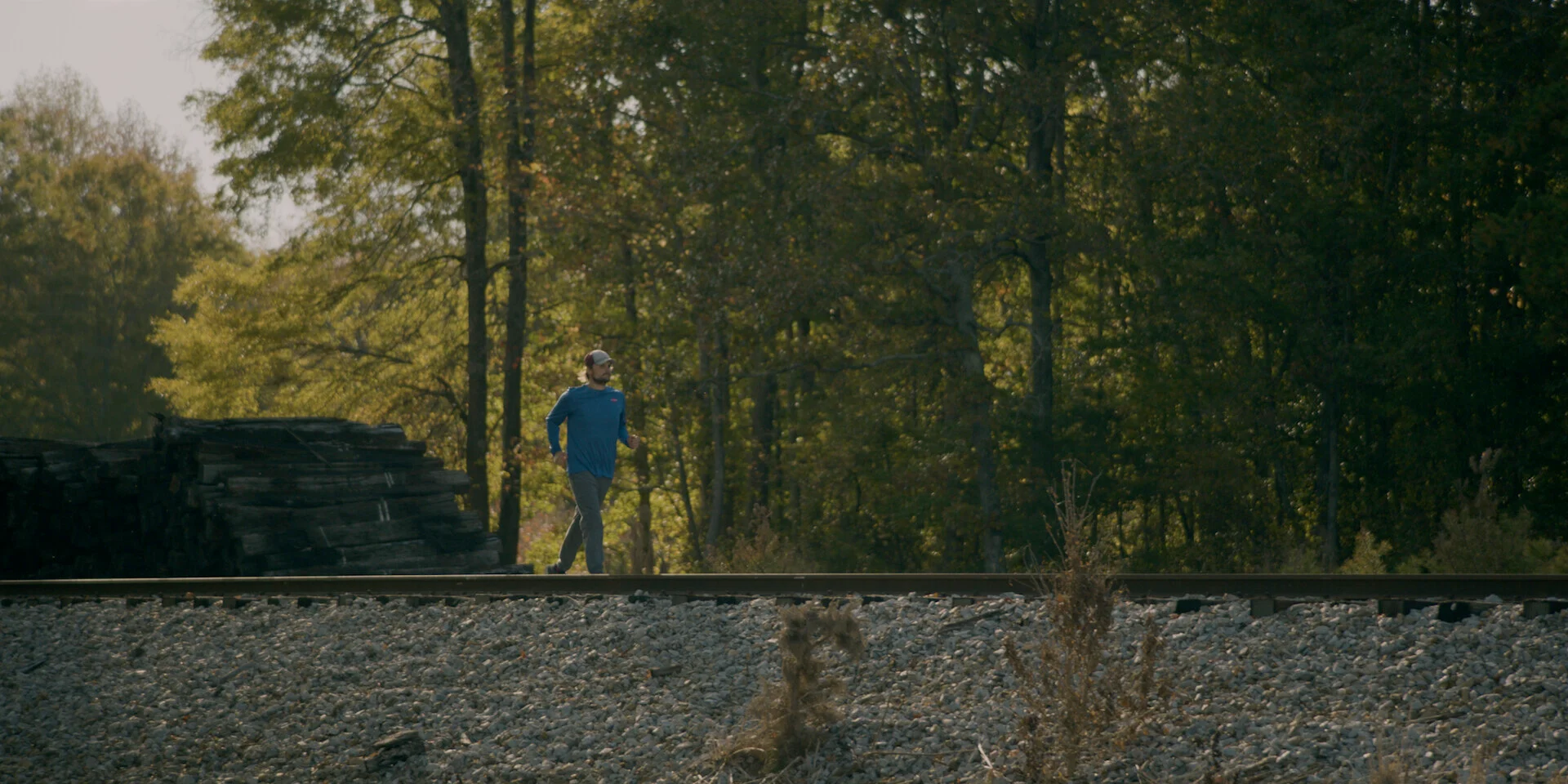 Landon walking along railroad tracks